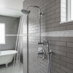 Polished chrome shower trim set on grey subway tiles in modern walk-in shower with water flowing