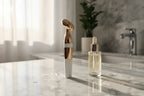 Galahome Sonic Face Massager on a luxury marble bathroom vanity with morning natural light next to a serum bottle