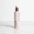 Daily skincare routine body cream pump bottle displayed with clean minimalist aesthetic on white marble surface