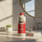 Herbal Clean QCarbo32 supplement drink bottle on bathroom vanity counter in warm morning light, lifestyle wellness photography