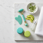 Minimalist spa arrangement with turquoise and avocado skincare essentials