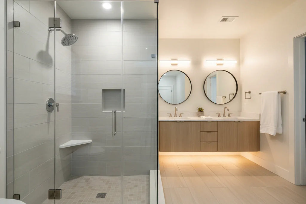 Modern home staging with chrome Moen showerhead in bright contemporary shower stall