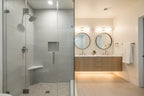 Modern home staging with chrome Moen showerhead in bright contemporary shower stall