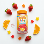 Emergen-C Kidz Gummies bottle on white surface with fresh strawberries and orange slices – More4less Outlet