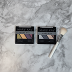 Mary Kay Mineral Eye Color Quad Autumn Leaves and Black Ice flat lay on white marble with makeup brush