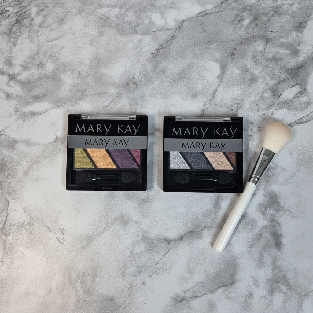Mary Kay Mineral Eye Color Quad Autumn Leaves and Black Ice flat lay on white marble with makeup brush
