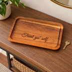 Treat Yo' Self engraved wood tray on an entryway table with a key nearby