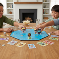 Disney Bitty Pop! Chase Game set up on family game table with players moving Mickey, Tiana, Dash, and Maleficent figures across the board.