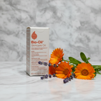 Bio-Oil Skincare Oil box beside fresh calendula flowers and lavender sprigs on white marble – More4less Outlet