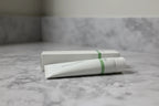 Minimalist professional bathroom setup with Rodan + Fields SOOTHE Calming Gel Cleanser tube and box on stone vanity
