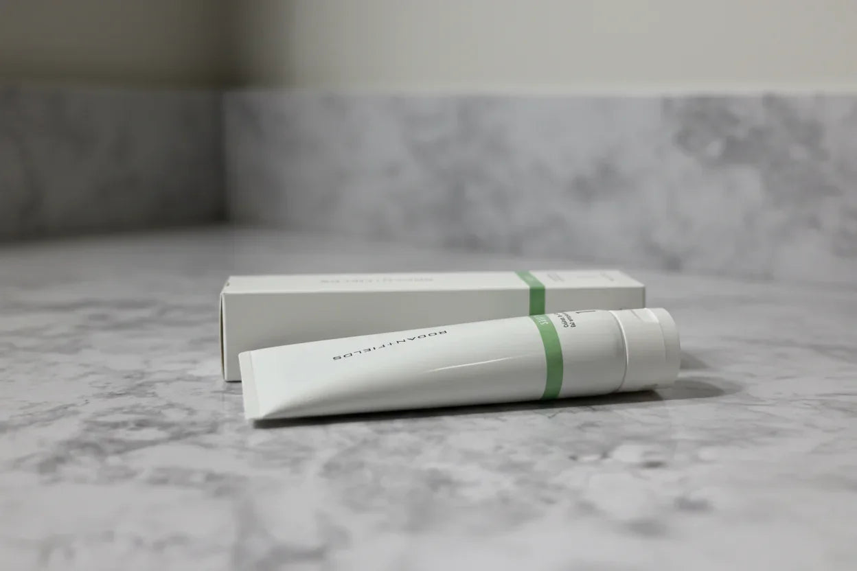 Minimalist professional bathroom setup with Rodan + Fields SOOTHE Calming Gel Cleanser tube and box on stone vanity