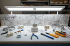 Professional workbench lighting illuminating electrical stove parts and appliance components
