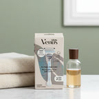 Gillette Venus Pubic Hair & Skin Razor Kit on quartz bathroom counter with premium bath towel and wellness glass bottle