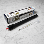Aqueon Pro 200 heater flat lay on white marble surface next to thermometer and suction cup, aquarium equipment lifestyle