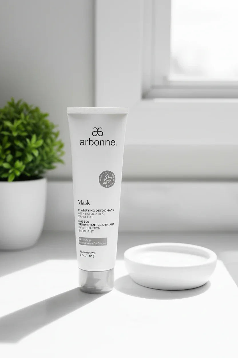 Arbonne Clarifying Detox Mask white tube on bright bathroom vanity with natural window light