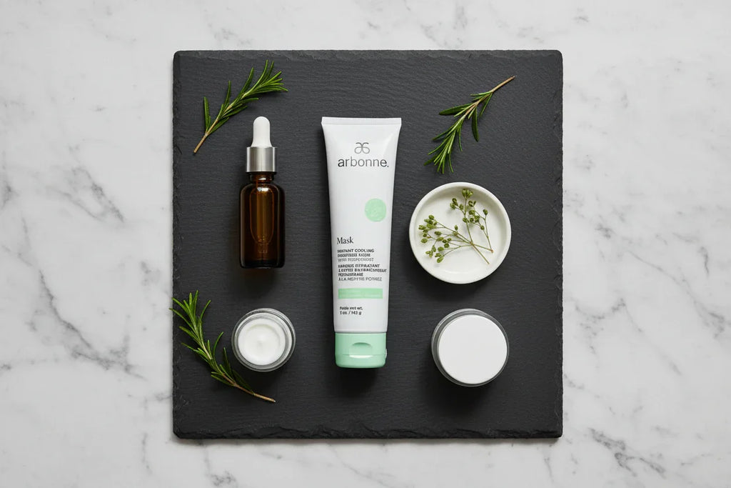 Arbonne Instant Cooling Moisture Mask skincare flat lay on slate surface with botanicals