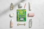 Professional flat lay of women's personal care and beauty supplies including razor and grooming essentials on white marble