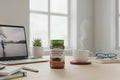 Nature's Truth Lion's Mane Gummies jar on modern office desk with laptop and coffee cup
