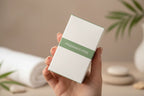 In-hand close-up of Garnier Green Labs premium white and sage green serum cream box highlighting fragrance-free labeling