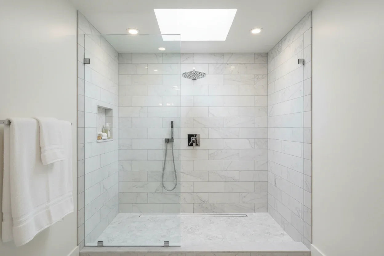 Luxury modern bathroom walk-in shower with polished chrome shower head on marble subway tile