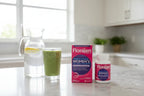 Florajen Women's Triple Action Probiotic 30ct box and bottle on white quartz kitchen island with water carafe and green smoothie — morning wellness routine