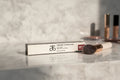 Arbonne Glossed Over Lip Gloss Anise on marble makeup vanity soft natural morning light lifestyle