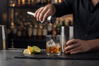 Houdini Double Jigger by Rabbit held by bartender pouring whiskey into cocktail shaker dark bar - More4less Outlet