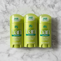 Five lime-green Ban Unscented solid deodorant sticks on white marble