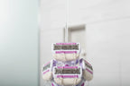 Close-up of water splashing over high-quality 5-blade women's razor cartridges in a bright shower setting