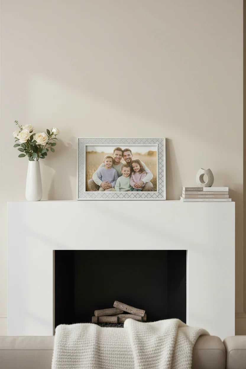 Malden silver glitter diamond picture frame holding family portrait on modern white fireplace mantle, warm interior lighting