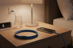 Belkin BoostCharge Pro Flex blue Lightning cable charging iPhone on nightstand with magnetic strap coiled — More4less Outlet