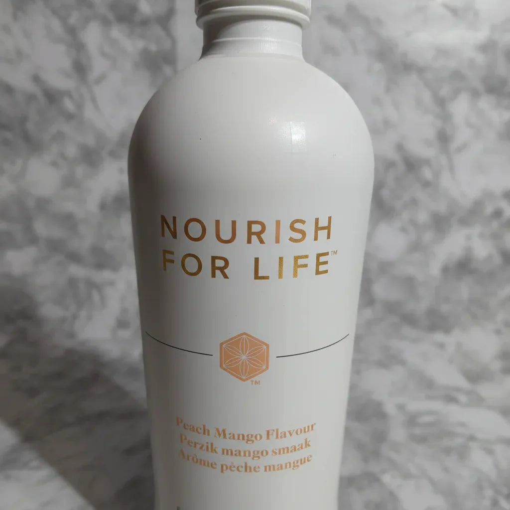 Close-up detail of premium white aluminum health tonic bottle with gold typography on marble counter, shallow depth of field