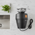 Moen Host EX75c garbage disposal on marble kitchen counter next to stainless sink and fresh herbs – More4less Outlet