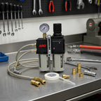 ARO C38231-600 FRL on industrial metal workbench with pneumatic fittings, Teflon tape, and wrenches for maintenance setup