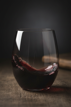 Deep red Cabernet wine swirling inside Riedel stemless crystal wine tumbler moody wine photography — More4less Outlet