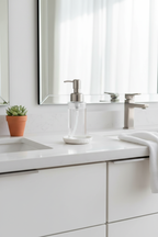 Sleek glass foaming soap dispenser on clean modern bathroom vanity