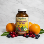 MegaFood Women Over 55 One Daily amber glass bottle beside fresh organic oranges cranberries and blueberries on white marble – More4less Outlet