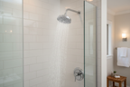 Moen Dartmoor polished chrome shower head in luxury modern bathroom with white subway tile