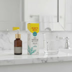 Burt's Bees Skin Balancing Gel Cream box on white marble bathroom vanity shelf next to premium facial serum dropper and glass of water