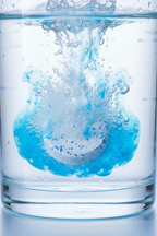 Macro view of concentrated cleaning tablet dissolving in clear water