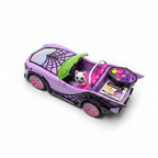 Overhead flat lay of the purple Monster High Ghoul Mobile toy car with ghost pet figure, coffin-shaped cooler, and drink accessories on a white surface.
