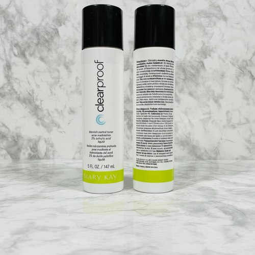 Two Mary Kay Clear Proof Blemish Control Toner 5 oz bottles standing side-by-side on marble countertop