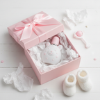 Lifestyle image — toddler cologne bottle as baby shower gift on white tissue paper in pink gift box with ribbon, sweet gifting flatlay for visual context only