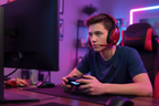 Turtle Beach Recon 70 red gaming headset worn by gamer at desk with PlayStation controller and RGB lighting — More4less Outlet