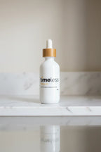 Elegant white glass dropper bottle on a minimalist marble shelf reflecting clean skincare standards