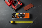 Paslode 902654 7.4V Li-Ion battery flatlay on dark slate with nailer and nail strips tool kit - More4less Outlet