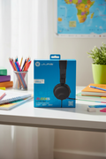 JLab JBuddies Learn headphones on desk with school supplies pencils and notebook