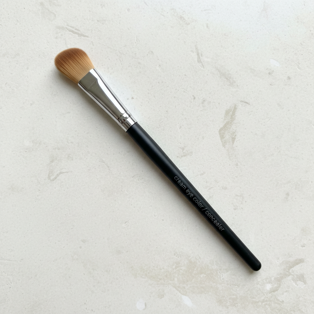 Mary Kay Cream Eye Color and Concealer Brush on a light stone surface