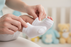 Parent putting Gerber Baby Wiggle Proof Stay On white socks on newborn's feet – More4less Outlet
