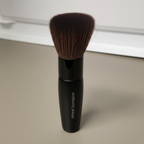 Mary Kay Mineral Foundation Brush at a three-quarter angle on a neutral surface